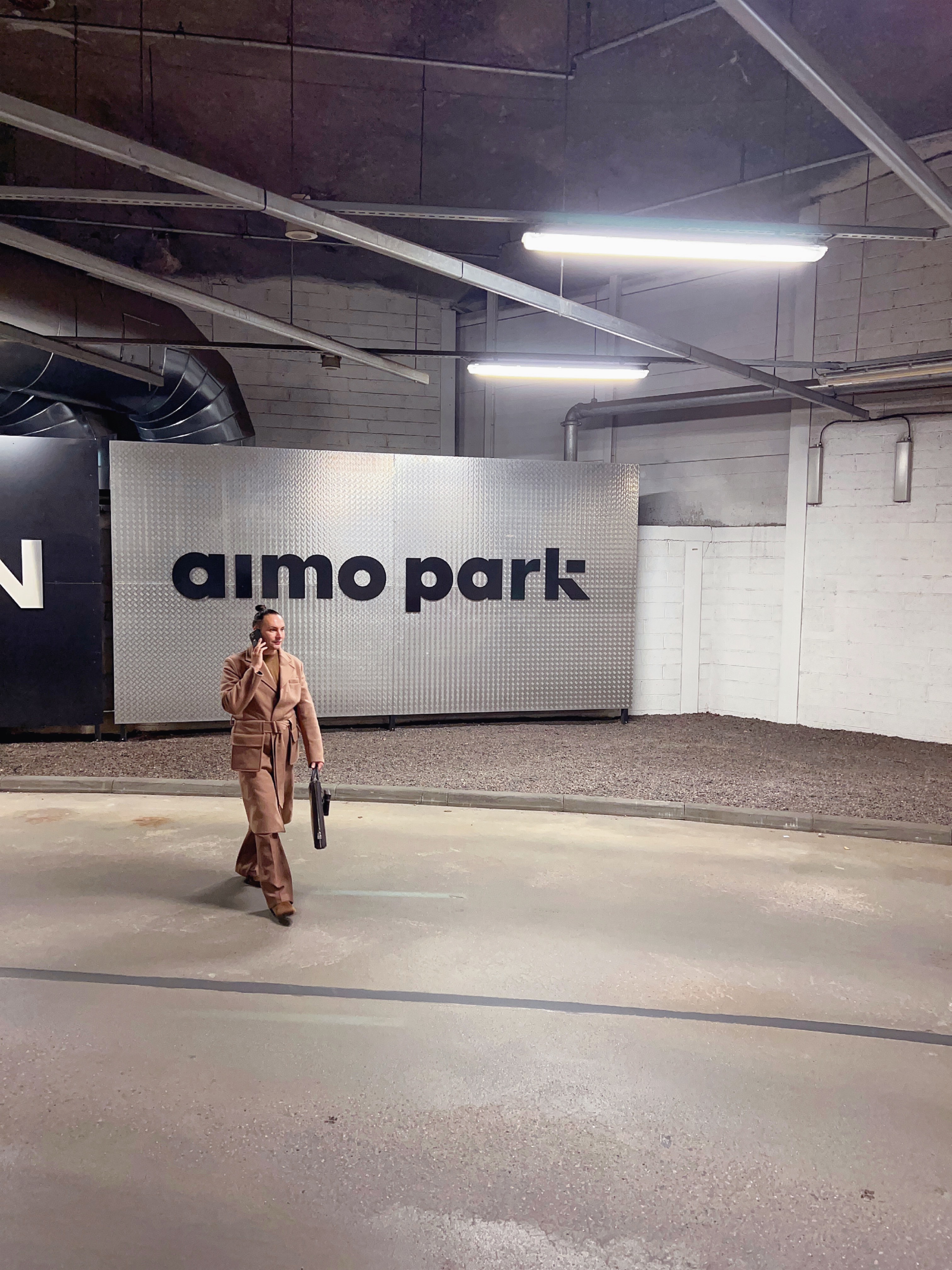 walking and talking on phone in stockmann helsinki parking facility